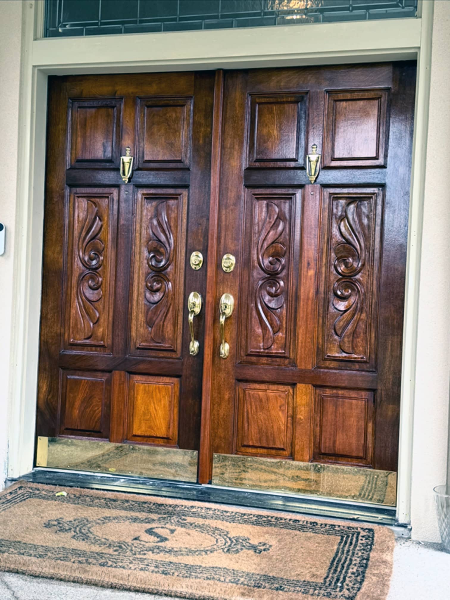 Decorative wooden double front doors with carved details in a Columbus-area residence